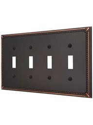 Imperial Bead Quad Gang Toggle Switch Plate in Aged Bronze.